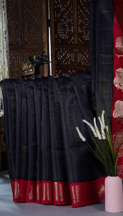 Green silk saree with all over golden zari  check weaving and contrast elephant borde - Navy