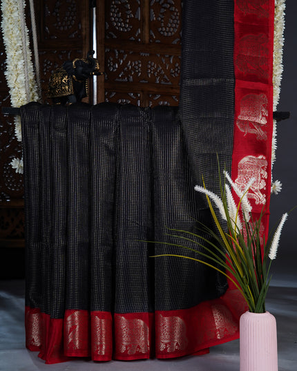 Green silk saree with all over golden zari  check weaving and contrast elephant border - Black